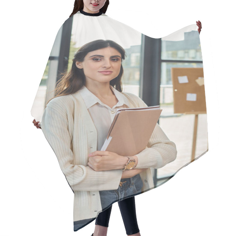 Personality  A Businesswoman Standing Confidently In A Modern Office, Holding A Binder Next To A Table. Hair Cutting Cape