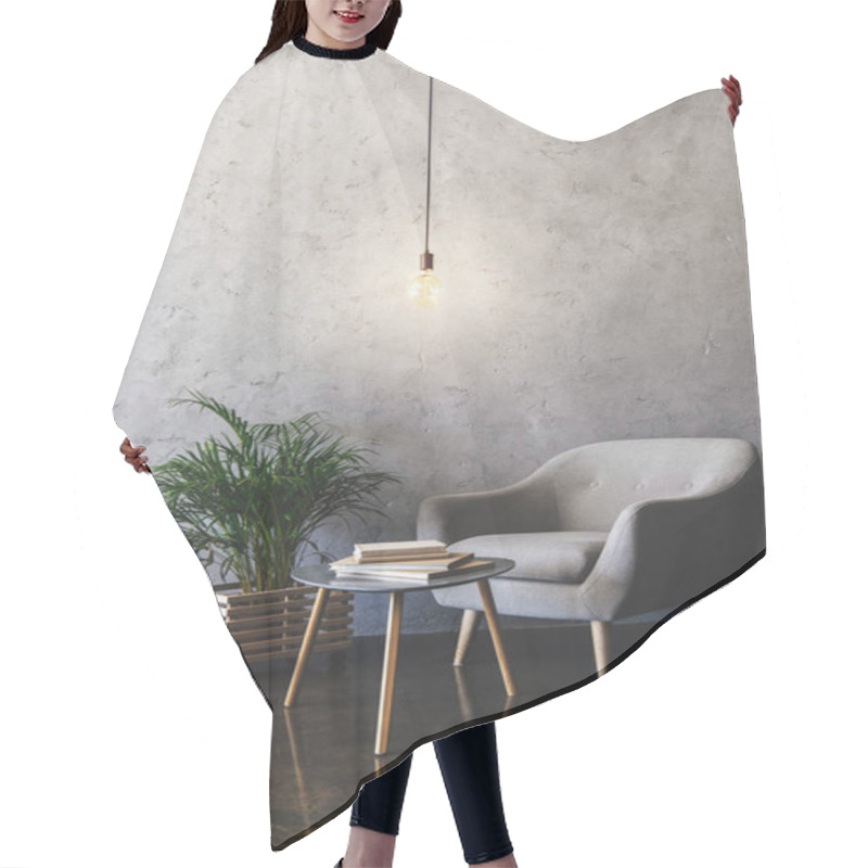 Personality  Interior Of Modern Room With Hanging Light Bulb, Table With Books, Plant And Armchair  Hair Cutting Cape