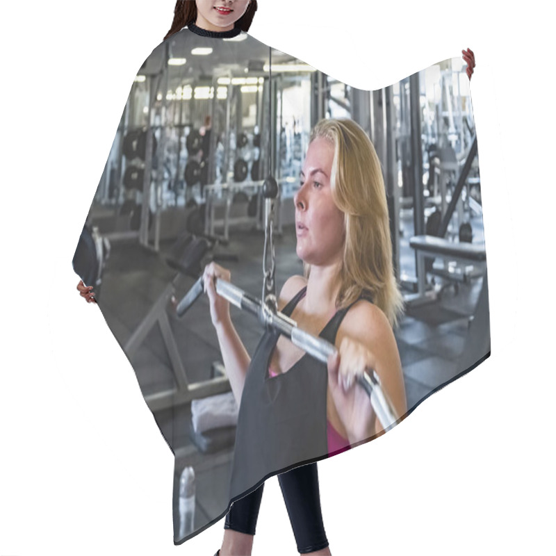 Personality  Young Fit Woman At The Gym Doing Pulldown Exercise With Weight Machine. Female Athlete At A Fitness Room Working Out With Weighted Pulley Machine Hair Cutting Cape