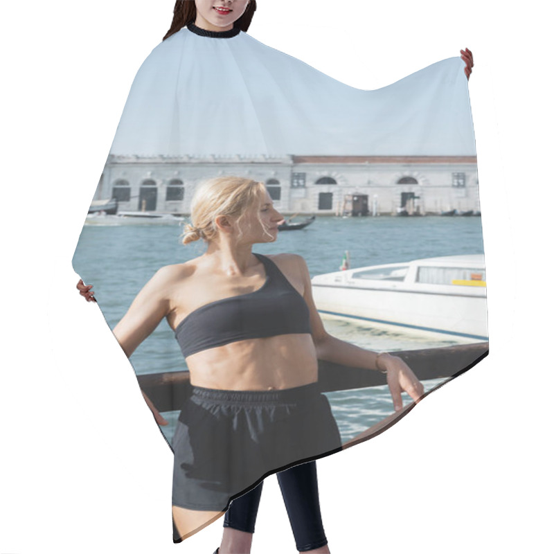 Personality  Side View Of Sportive Blonde Woman In Black Crop Top And Shorts Standing On Wooden Pier In Venice  Hair Cutting Cape