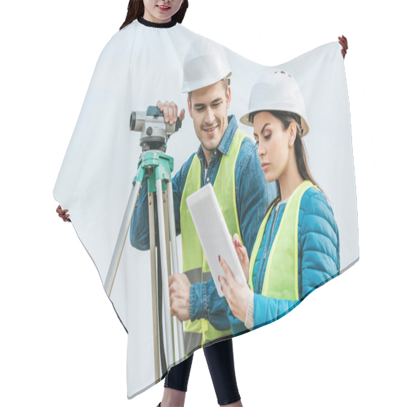 Personality  Surveyors With With Digital Level Looking At Tablet  Hair Cutting Cape