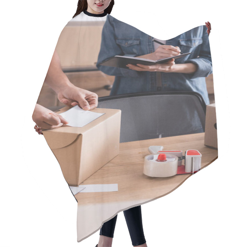 Personality  Cropped View Of African American Seller Applying Shipping Label On Carton Box Near Colleague Writing On Notebook In Online Web Store  Hair Cutting Cape