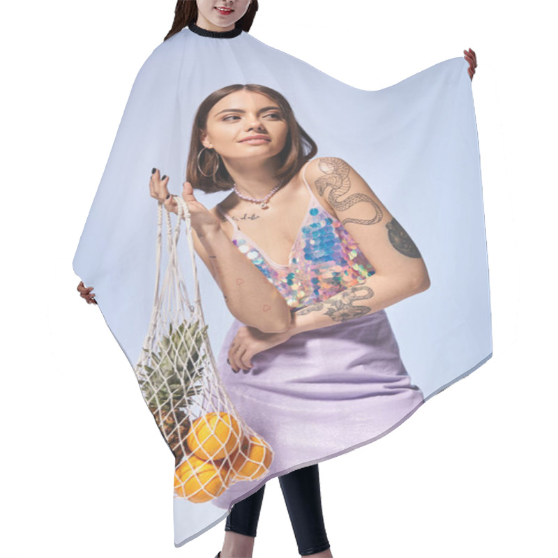 Personality  A Brunette Woman With Tattoos Holds A Bag Filled With An Assortment Of Fresh Fruit, Showcasing A Blend Of Nature And Art. Hair Cutting Cape