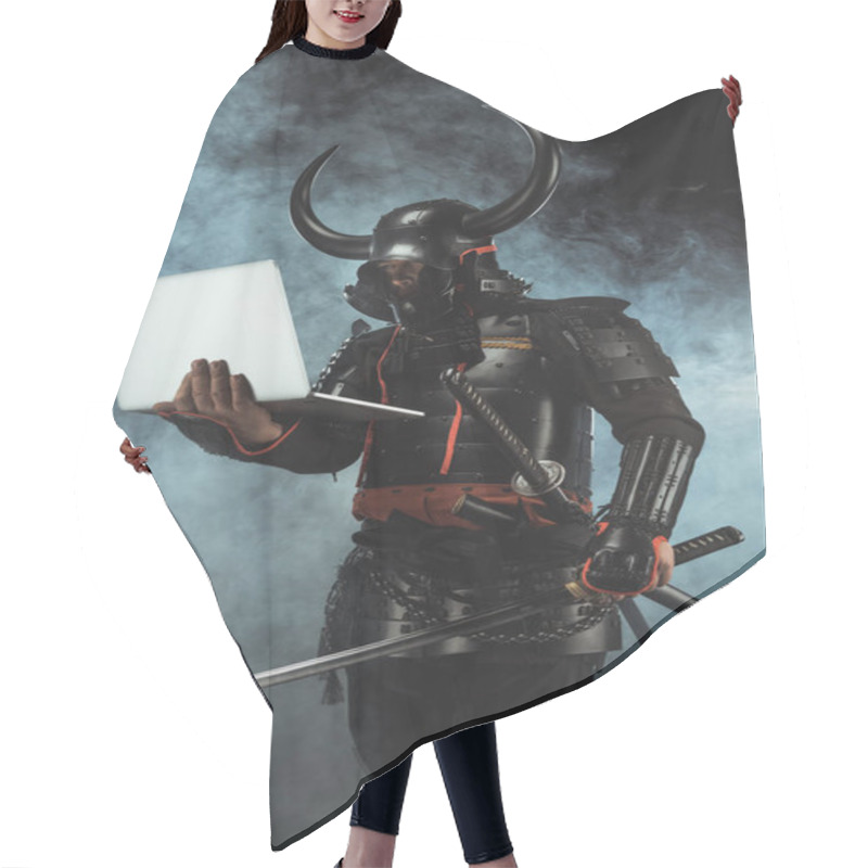 Personality  Samurai In Traditional Armor Holding Laptop On Dark Background With Smoke Hair Cutting Cape