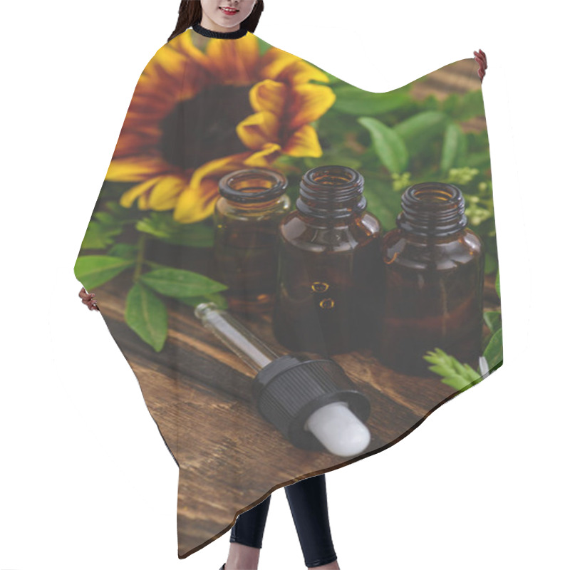 Personality  Bottles With Essential Oils, Dropper And Sunflower On Wooden Surface Hair Cutting Cape