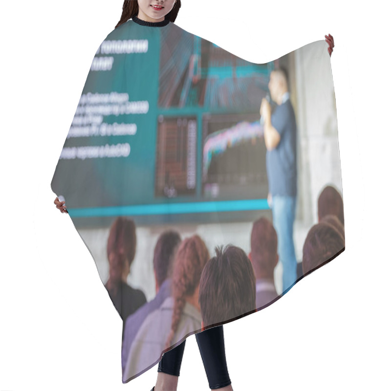 Personality  Audience Attentively Watches Speaker During A Tech Conference, Featuring Data Visualization On Screen. Hair Cutting Cape