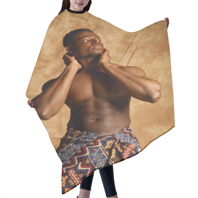 Personality  A Young Handsome African American Man, Showcasing His Physique, Stands Confidently With His Hands On His Neck. He Wears A Traditional Patterned Wrap, Exuding Charm And Charisma In An Artistic Setting. Hair Cutting Cape