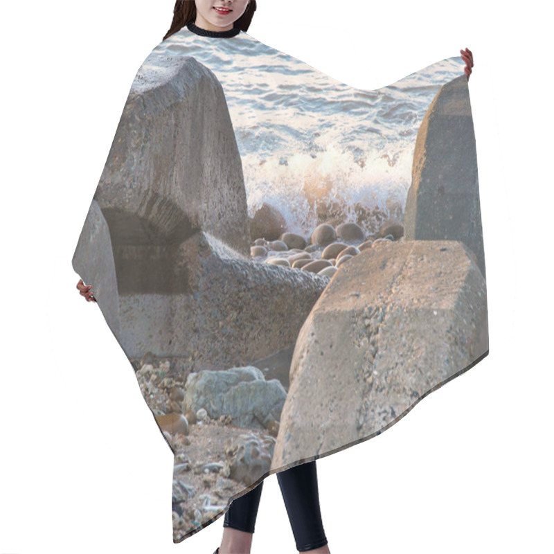 Personality  Massive Concrete Blocks Rest On A Rocky Shoreline, With Gentle Waves Crashing And Splashing In The Background Under Soft Light. Hair Cutting Cape