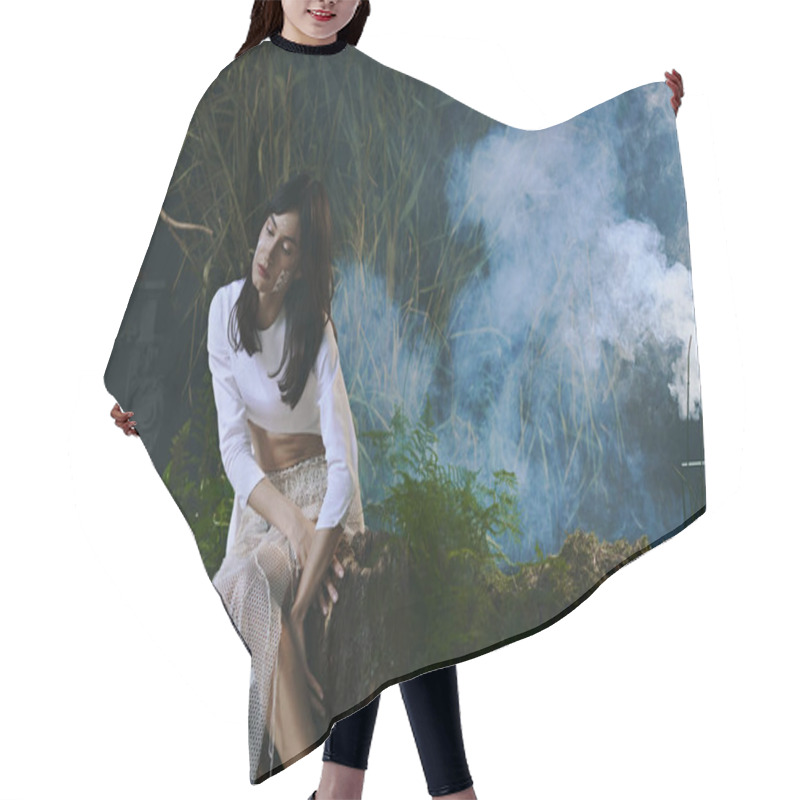 Personality  A Woman Dressed In White Poses Amidst A Smoky, Natural Setting. Hair Cutting Cape