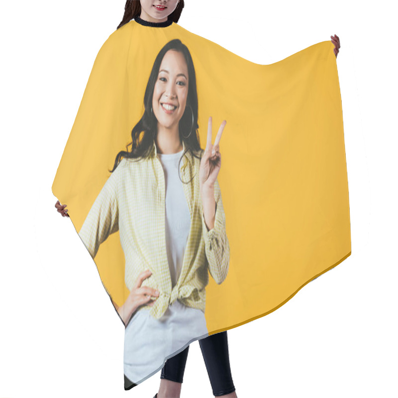 Personality  Beautiful Asian Girl Showing Victory Sign Isolated On Yellow Hair Cutting Cape