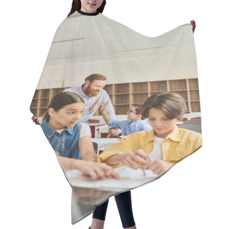 Personality  A Group Of People, Including A Man Teacher, Sitting At Desks In A Bright, Lively Classroom, Engaging In A Lesson. Hair Cutting Cape