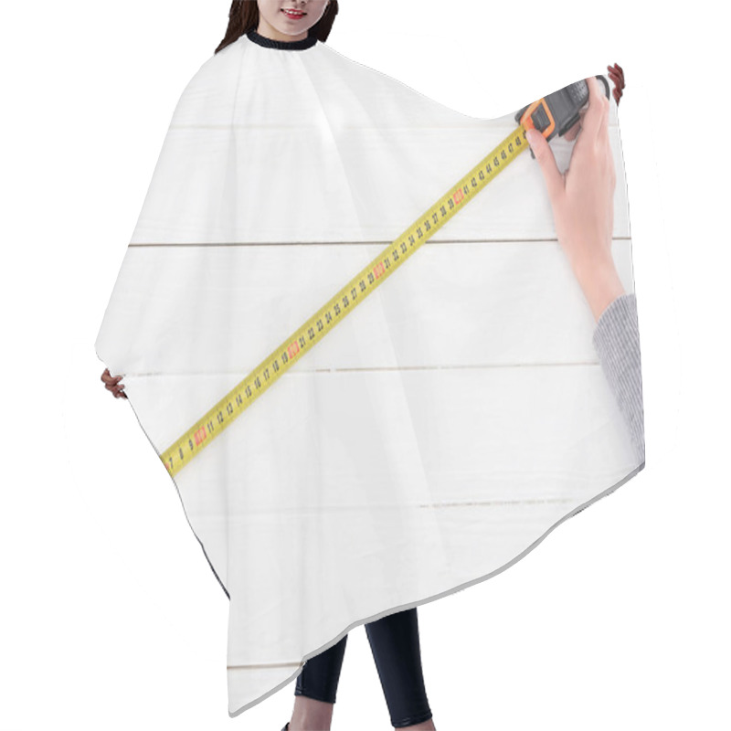 Personality  Cropped View Of Man Holding Industrial Measuring Tape On White Wooden Background Hair Cutting Cape