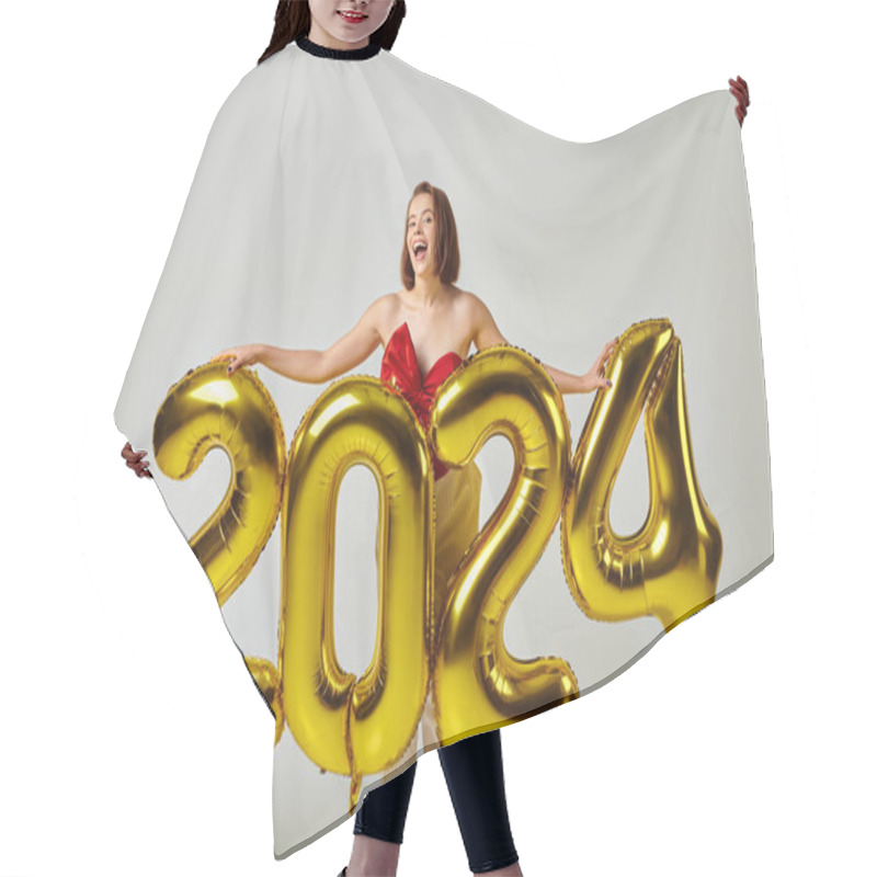 Personality  Happy New Year, Excited Young Woman In Trendy Attire Holding Balloons With 2024 Numbers On Grey Hair Cutting Cape