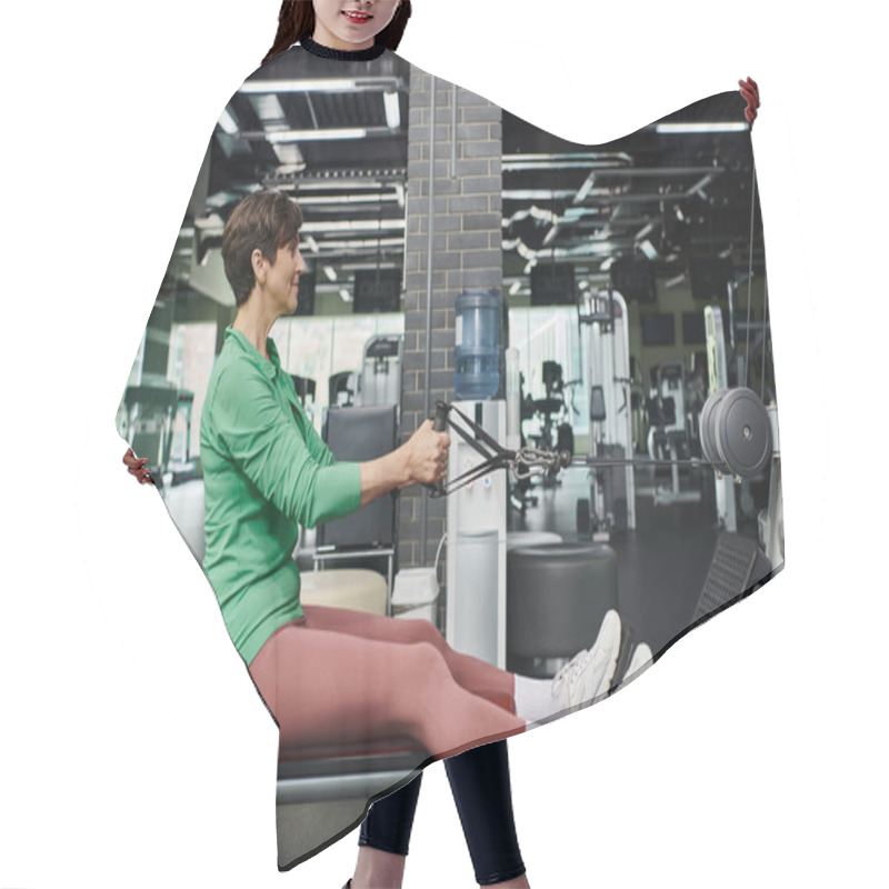 Personality  Athletic And Motivated, Elderly Woman Working Out In Gym, Fitness, Exercise Machine, Side View Hair Cutting Cape