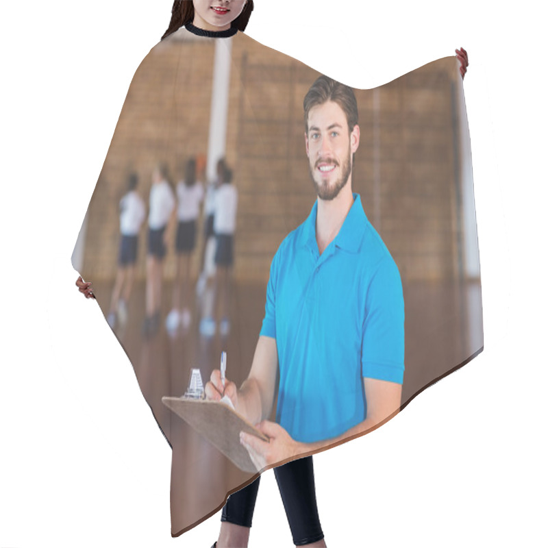 Personality  Portrait Of Sports Teacher Writing On Clipboard Hair Cutting Cape