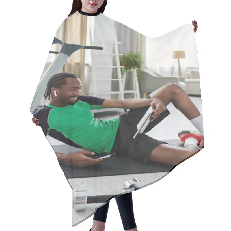 Personality  Young Man Enjoys A Relaxing Moment While Exercising And Using Technology In A Stylish Interior. Hair Cutting Cape