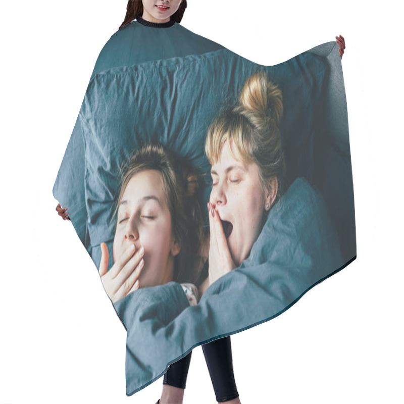 Personality  Portrait Of Light Hair Long Hair Mother And Daughter On Pillow Under The Duvet Together Yawn In Soft Sleepy Morning Light On Blue Linen Bed. Concept Of Happy Family Living, Relaxation, Comfort, Fun.  Hair Cutting Cape