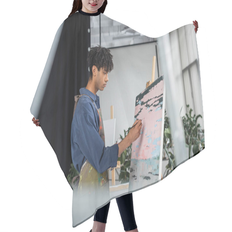 Personality  Side View Of Young African American Artist In Apron Painting On Canvas  Hair Cutting Cape