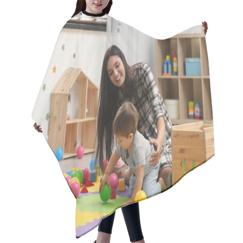 Personality  Young Nanny And Cute Little Baby Playing With Toys At Home Hair Cutting Cape