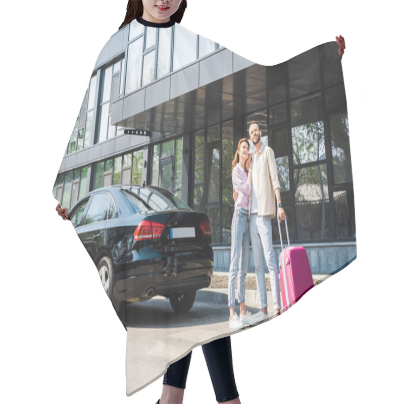 Personality  Cheerful Man Hugging Happy Woman While Standing Near Black Car With Pink Luggage  Hair Cutting Cape