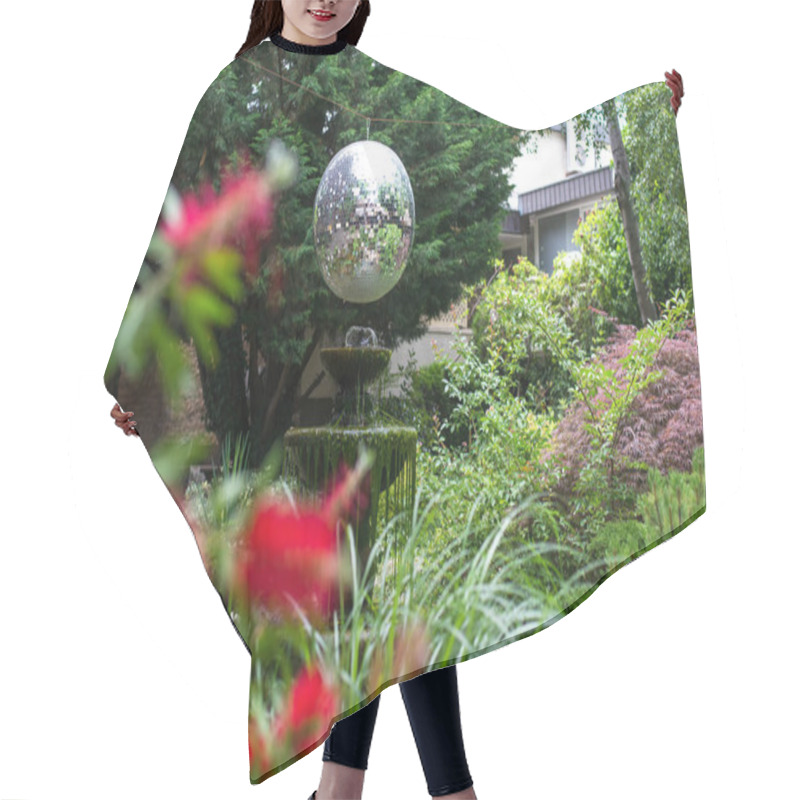 Personality  Garden Exterior With Fountain, Trees, Bushes, Flowers And Attractive Shiny Ball. Selective Focus. Hair Cutting Cape