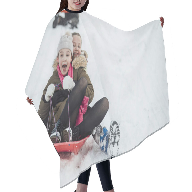 Personality  Two Little Girls Are Going Down A Snowy Hill Together On A Sleigh. Hair Cutting Cape