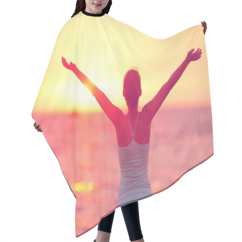 Personality  Wellness, Well-being And Happiness Concept. Silhouette Of Woman With Open Arms Raised To The Sky On Sunset Beach Practicing Yoga. Hair Cutting Cape