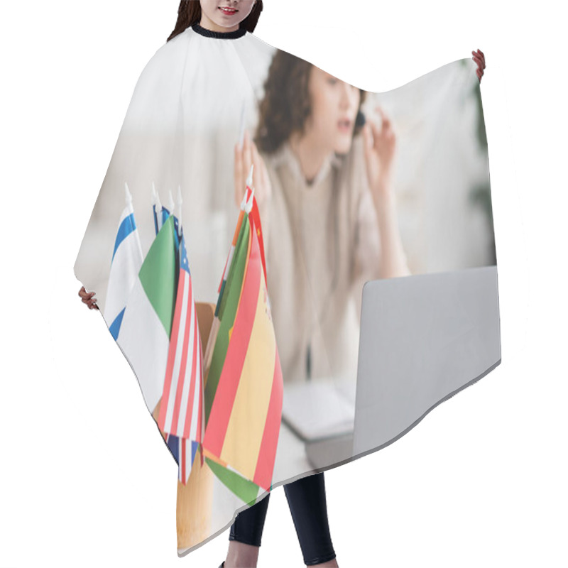 Personality  Selective Focus Of Different International Flags Near Laptop And Blurred Language Teacher Working At Home Hair Cutting Cape