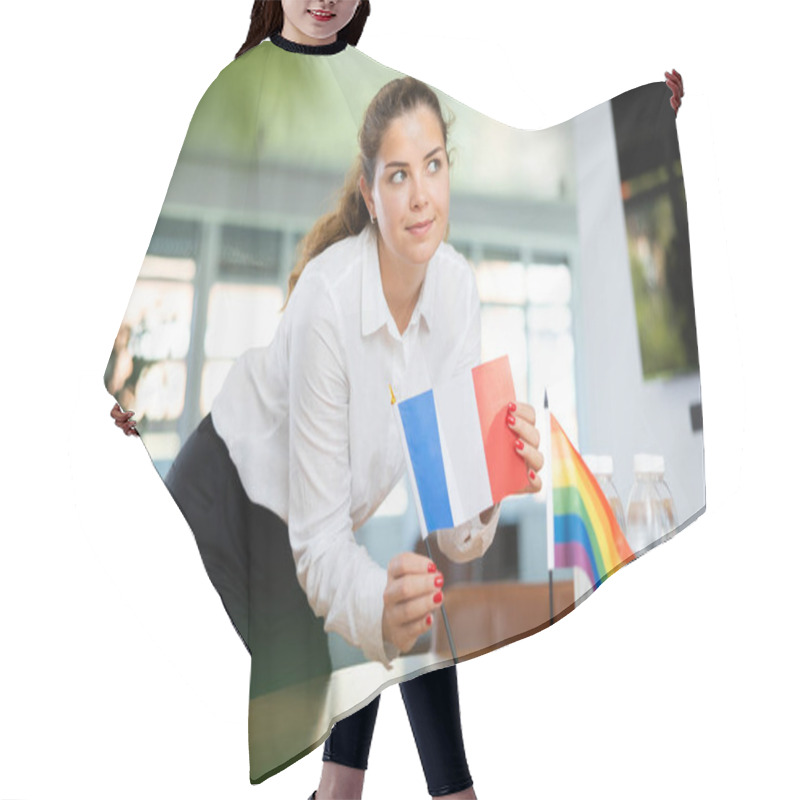 Personality  Young Woman In Business Clothes Puts Flags Of France And LGBT On Negotiating Table In Office Hair Cutting Cape