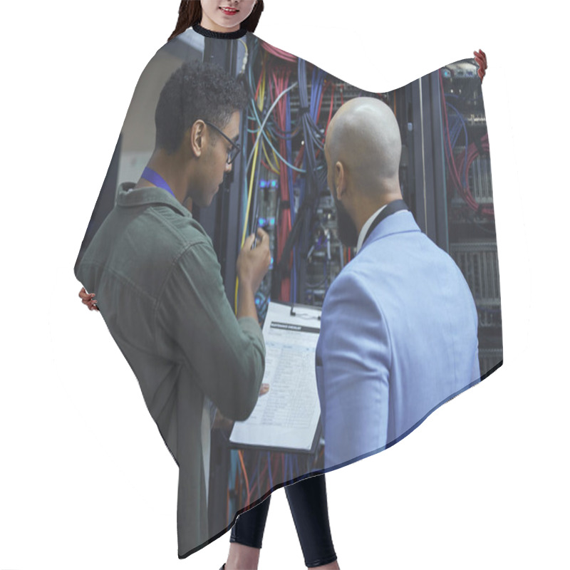 Personality  Explaining The Ins And Outs. Two Male IT Support Agents Working Together In A Dark Network Server Room Hair Cutting Cape