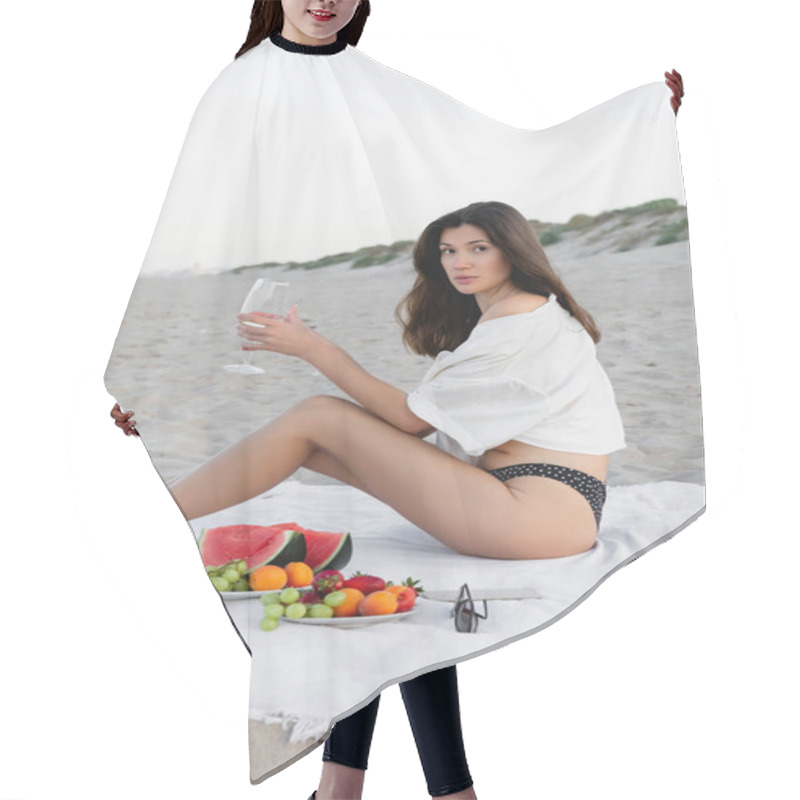 Personality  Brunette Woman In Shirt Holding Wine And Looking At Camera Near Fruits And Sunglasses On Blanket On Beach  Hair Cutting Cape