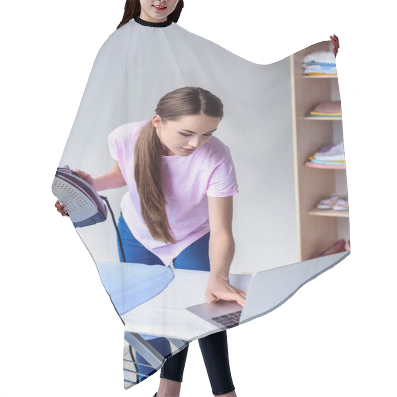 Personality  Young Woman Ironing Clothing And Working With Laptop At Home Hair Cutting Cape