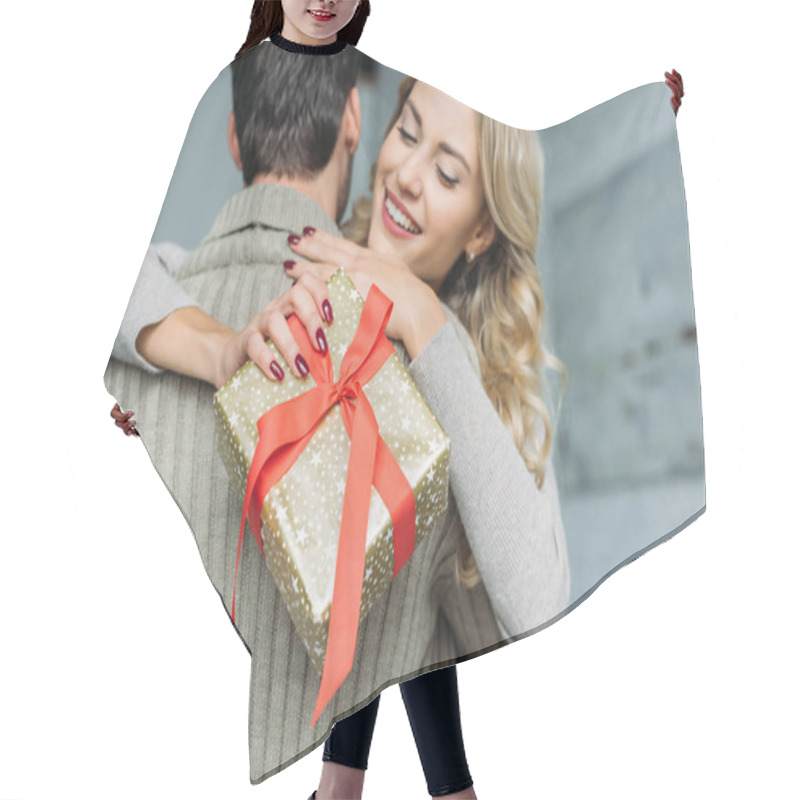 Personality  Beautiful Young Woman With Gift Box Embracing Her Boyfriend At Home Hair Cutting Cape