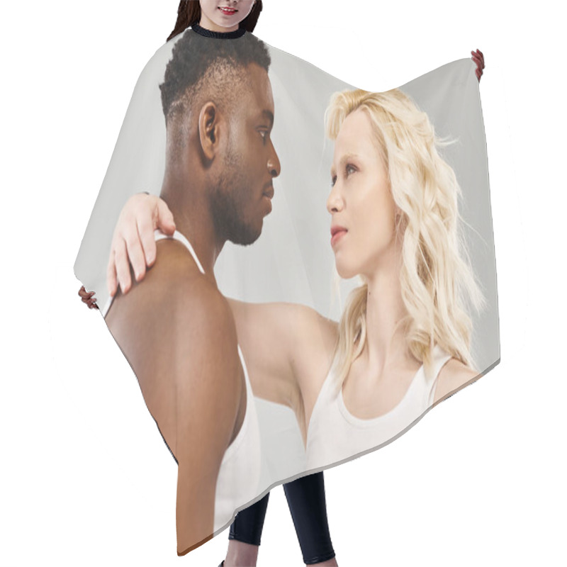 Personality  A Young Multicultural Couple Standing Closely Together In A Studio Against A Grey Background. Hair Cutting Cape