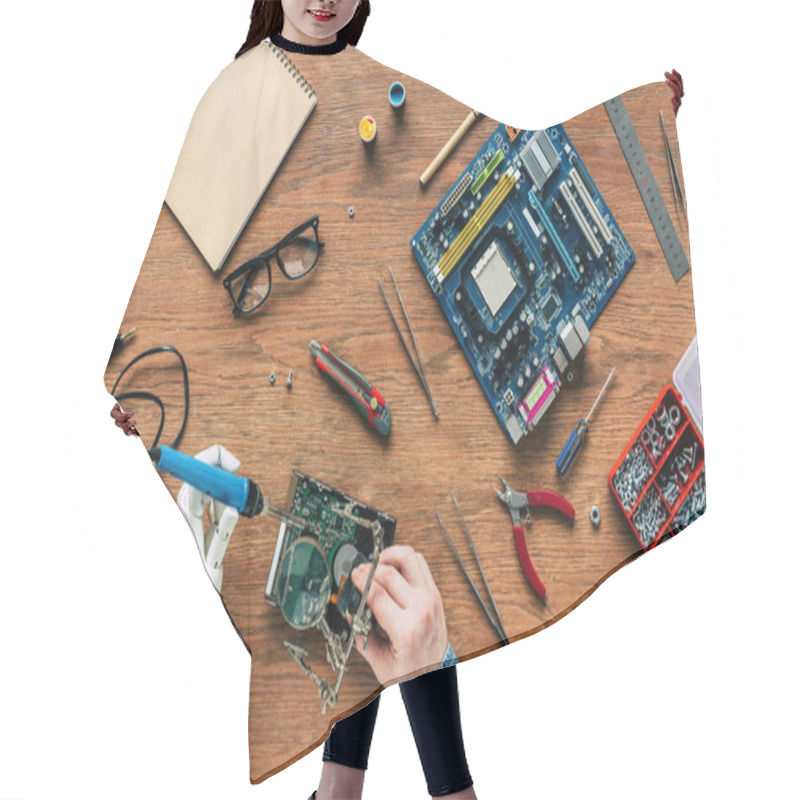 Personality  Cropped Image Of Man With Prosthetic Arm Repairing Hard Drive By Soldering Iron Hair Cutting Cape