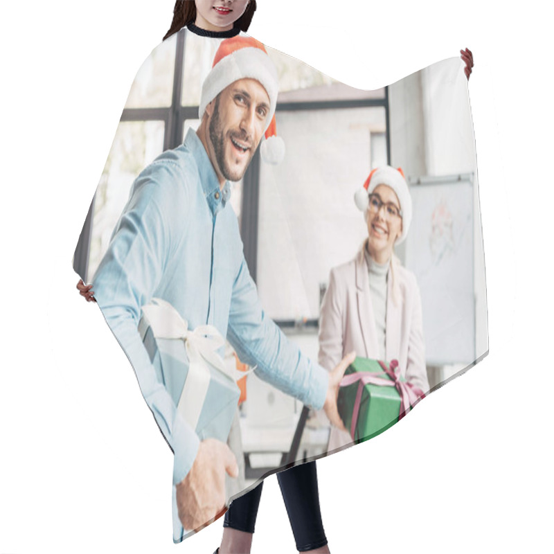 Personality  Happy Young Businessman Presenting Christmas Gift To Female Colleague In Office  Hair Cutting Cape