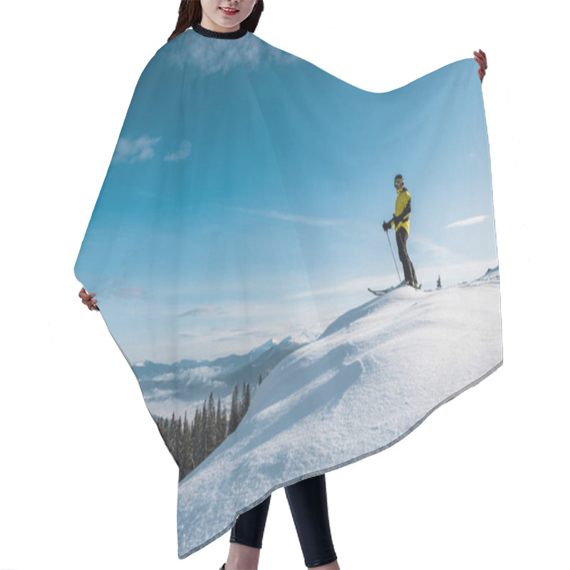 Personality  Skier Holding Ski Sticks And Standing Against Blue Sky In Mountains  Hair Cutting Cape