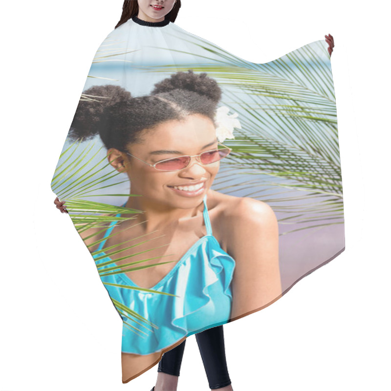 Personality  Smiling African American Woman In Sunglasses With Flower In Hair Near Palm Leaves In Front Of Sea Hair Cutting Cape