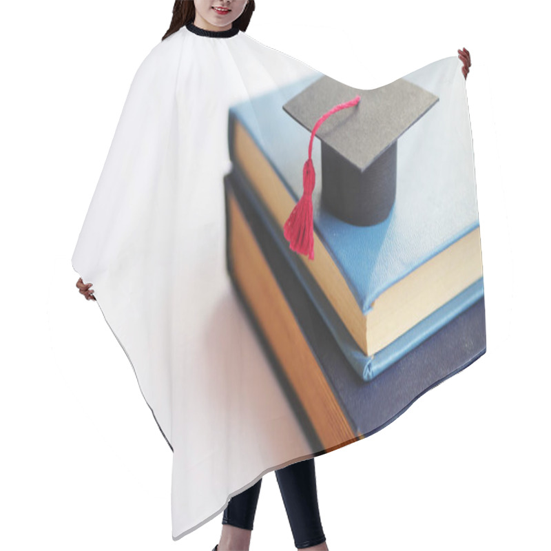 Personality  Back To School. Student Cap On Stack Of Books. Educational Concept  Hair Cutting Cape