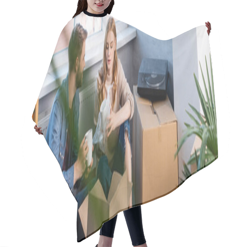 Personality  Selective Focus Of Joyful Woman Holding Cup While Unpacking Box With Boyfriend, Panoramic Shot  Hair Cutting Cape