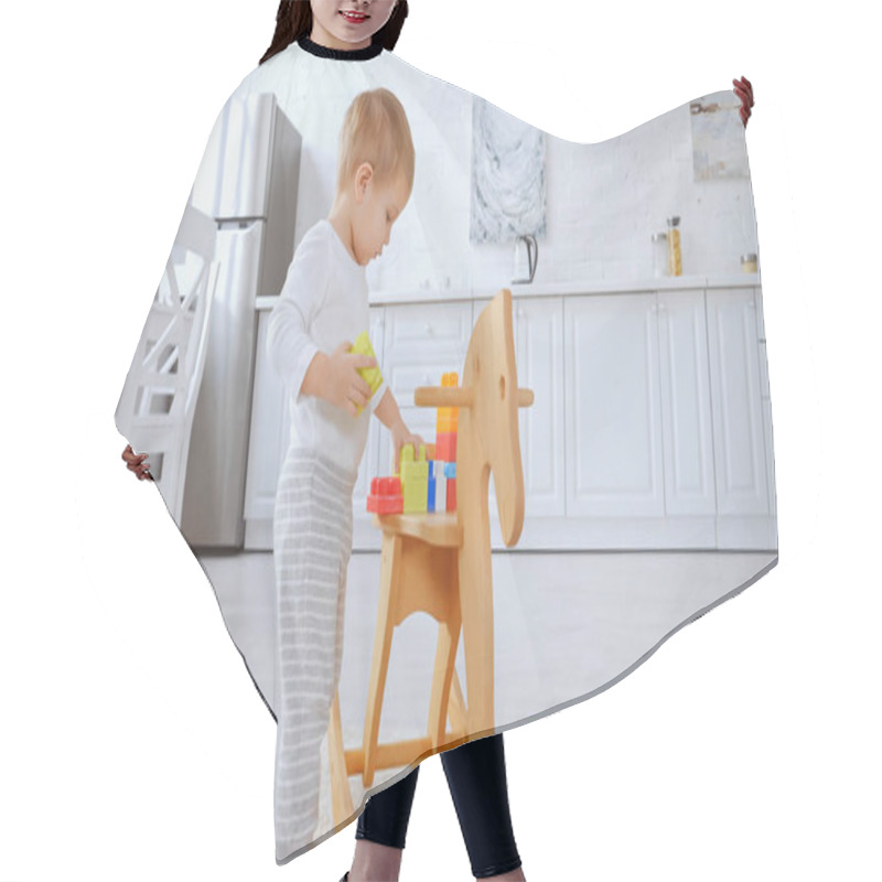 Personality  Toddler Child Playing With Building Blocks On Rocking Horse In Spacious Apartment  Hair Cutting Cape