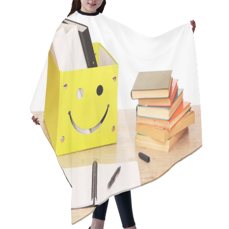 Personality  There Is A Yellow Box On The Table In The Library With Documents And Research Materials For The Preparation Of The Report. Classroom Teacher's Desk With Teaching Materials. Hair Cutting Cape