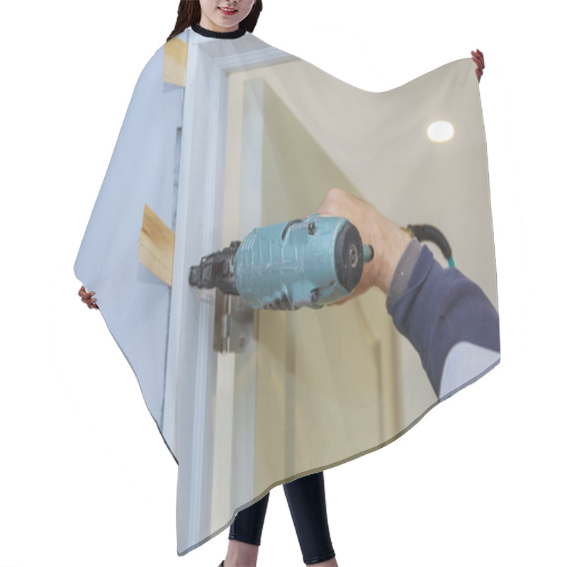 Personality  Worker In Using Air Nail Gun Installing The Interior Door Hair Cutting Cape