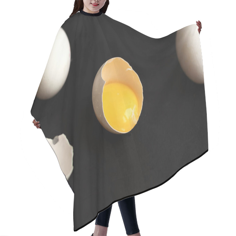 Personality  White Eggs Lie Scattered On A Black Background. One Egg Is Broken And The Yolk Is Visible. Minimalistic Design And Color Trend 2020. Top View. Hair Cutting Cape