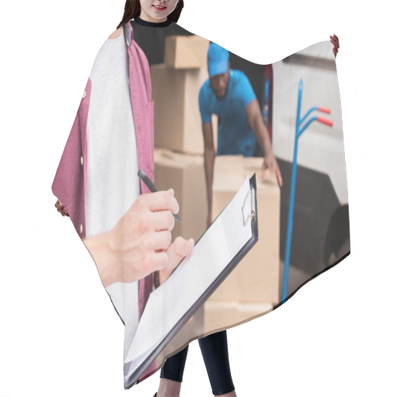 Personality  Cropped Image Of Customer Holding Clipboard Hair Cutting Cape