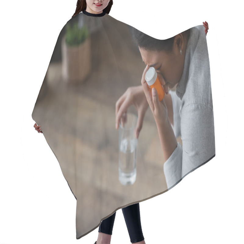 Personality  Dissatisfied Multiracial Woman Holding Pills And Blurred Glass Of Water At Home  Hair Cutting Cape