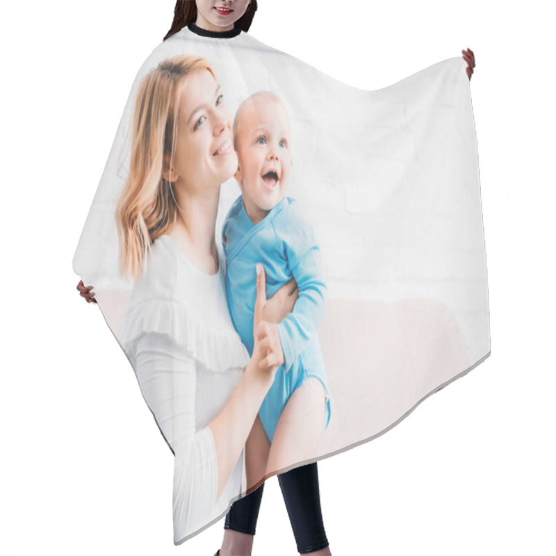 Personality  Smiling Mother Embracing Happy Child At Home Hair Cutting Cape