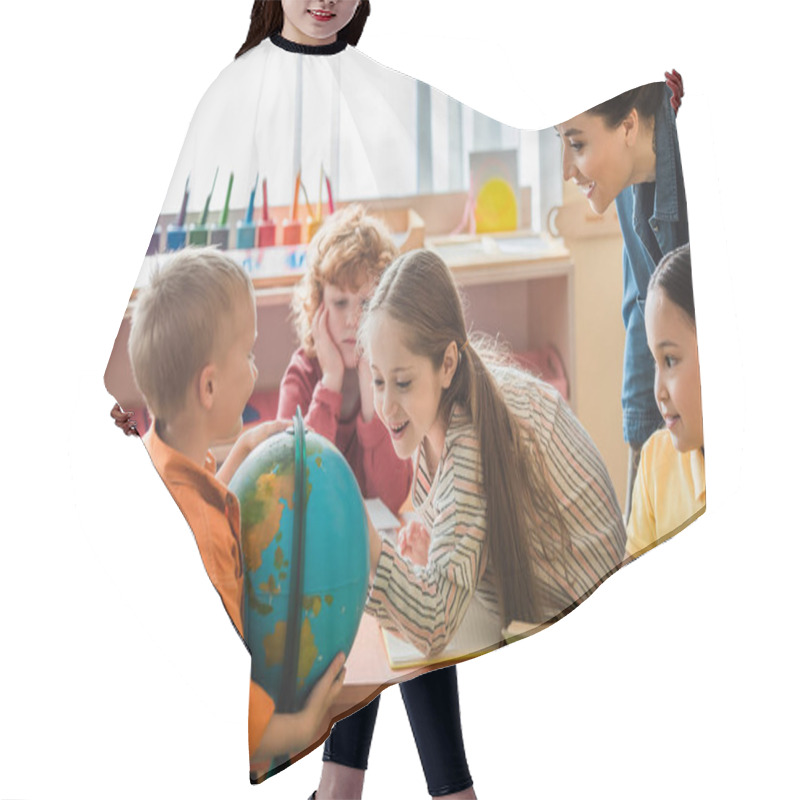 Personality  Amazed Girl Looking At Globe Near Interracial Friends And Teacher Hair Cutting Cape