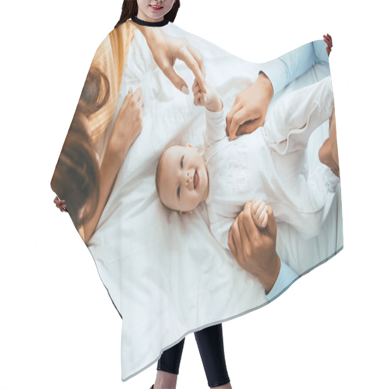 Personality  Top View Of Parents Touching Smiling Infant Lying On White Bedding Hair Cutting Cape