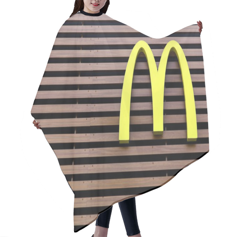 Personality  McDonald's logo on a wall hair cutting cape